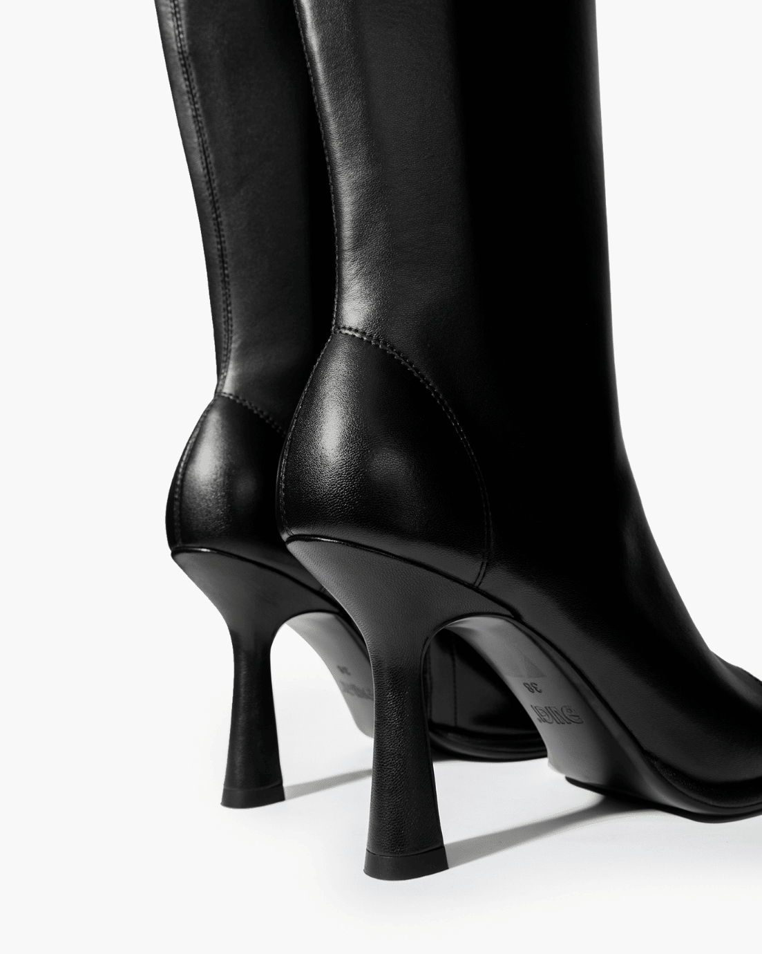 Black knee-high boots with high flared heel and tonal stitching