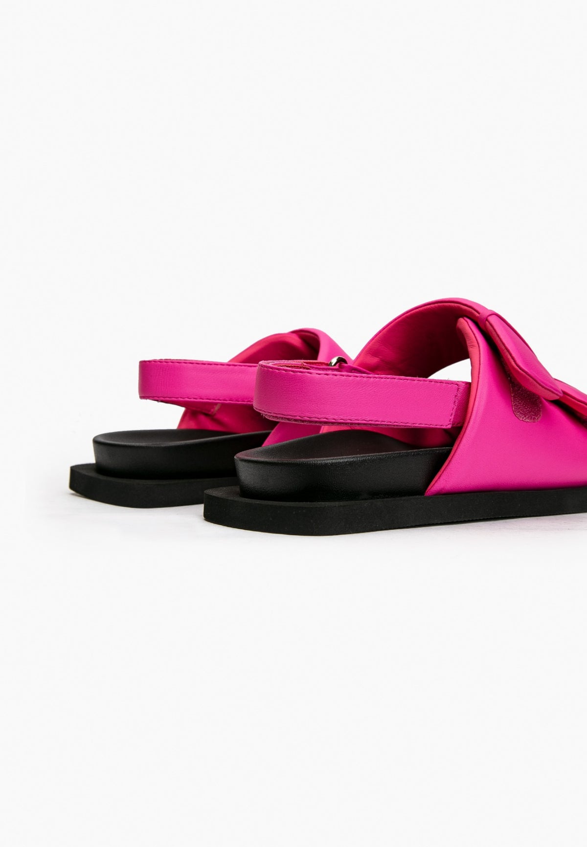 Rear view of hot pink leather sandals with adjustable heel straps