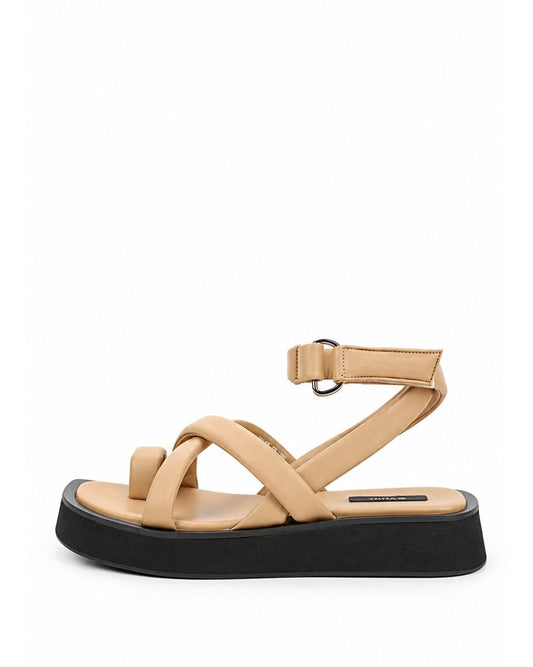 Warm beige leather toe-loop platform sandal with crossover straps and black sole, side profile