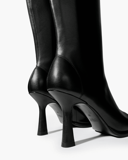 Black knee-high boots with high flared heel and tonal stitching