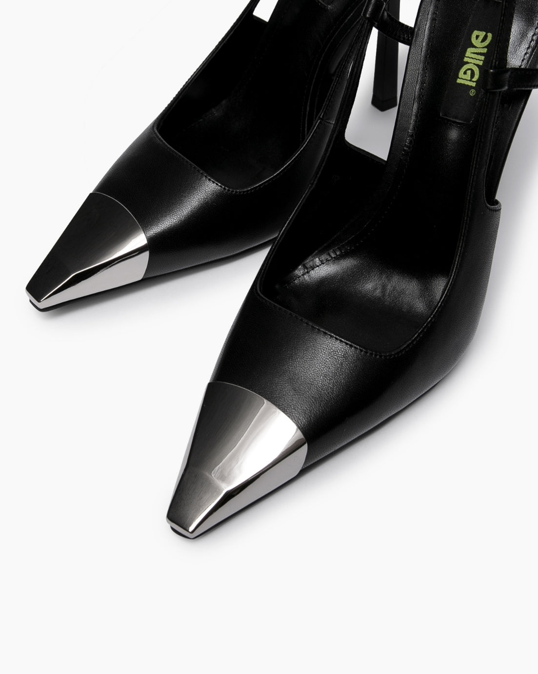 Close-up of polished metal toe caps on black leather pointed slingback heels