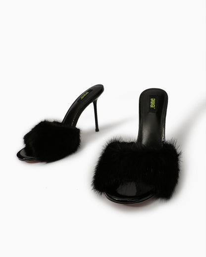 Black natural fur mule heels, front three-quarter view
