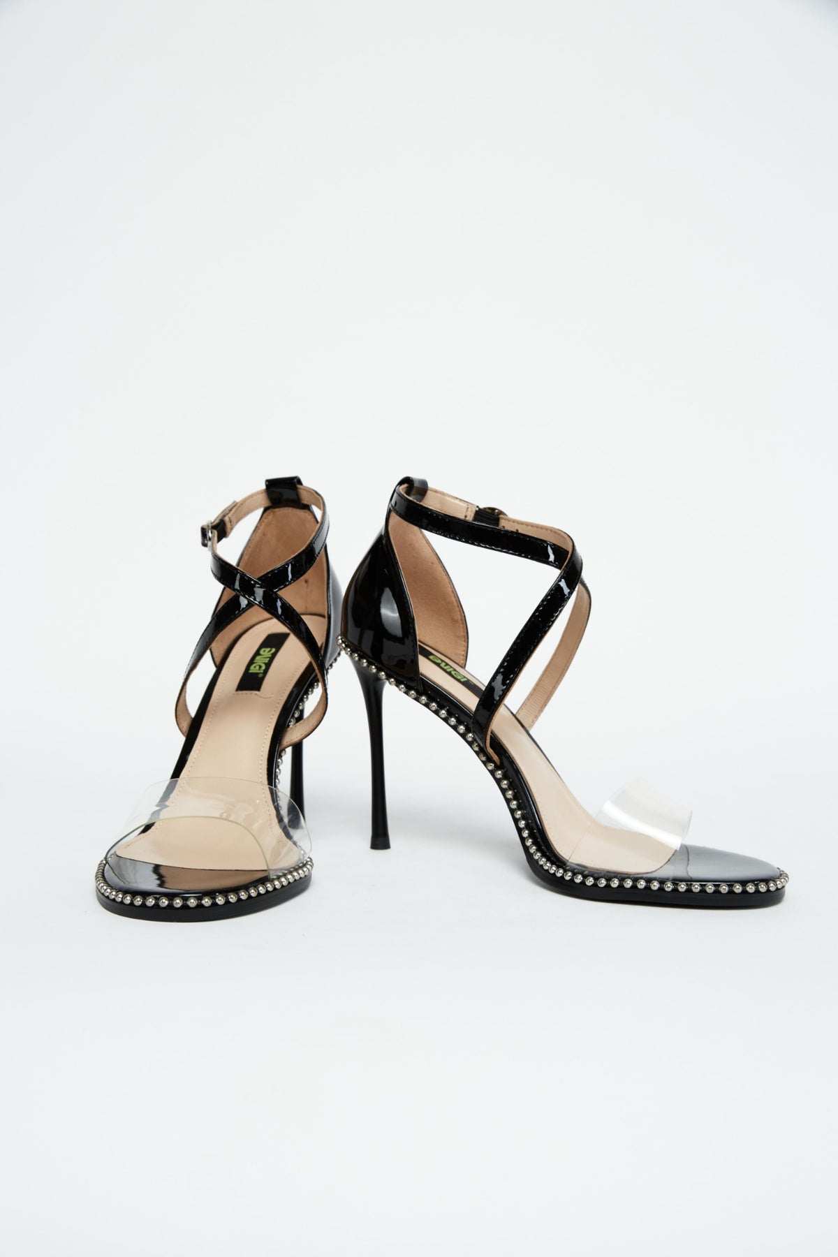 Front and side views of black patent stiletto heels with silver trim