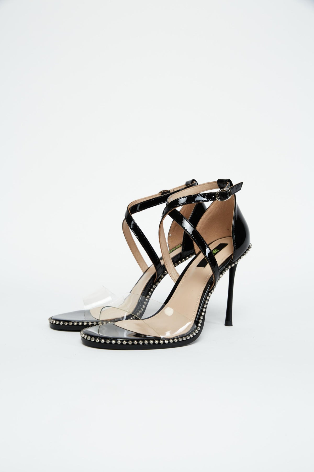 Pair of black patent heels with clear PVC toe straps and crossed ankle straps