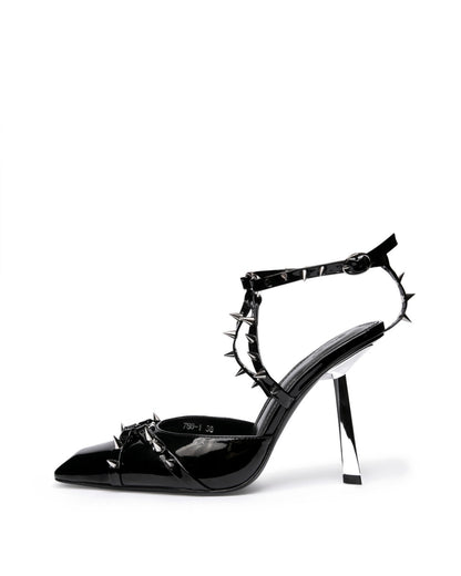 Black patent leather heels with silver-tone spikes and a sculptural silver-tone heel — side view