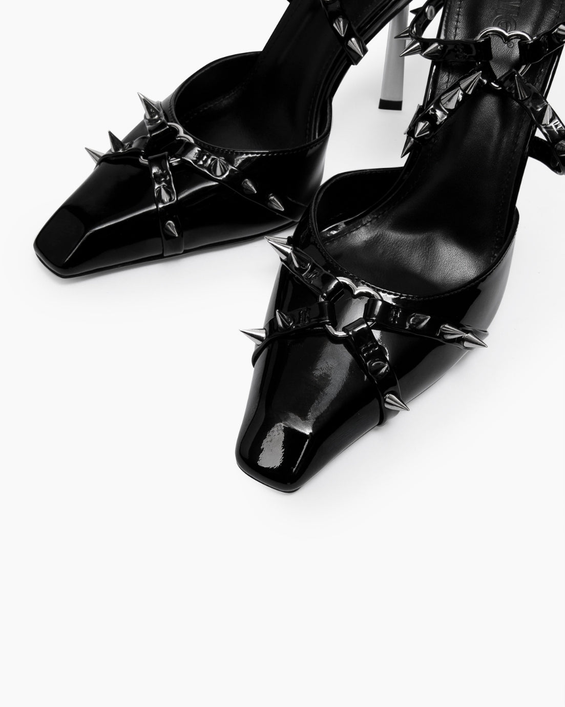 Black patent leather heels — square toe, spike and heart-shaped ring details