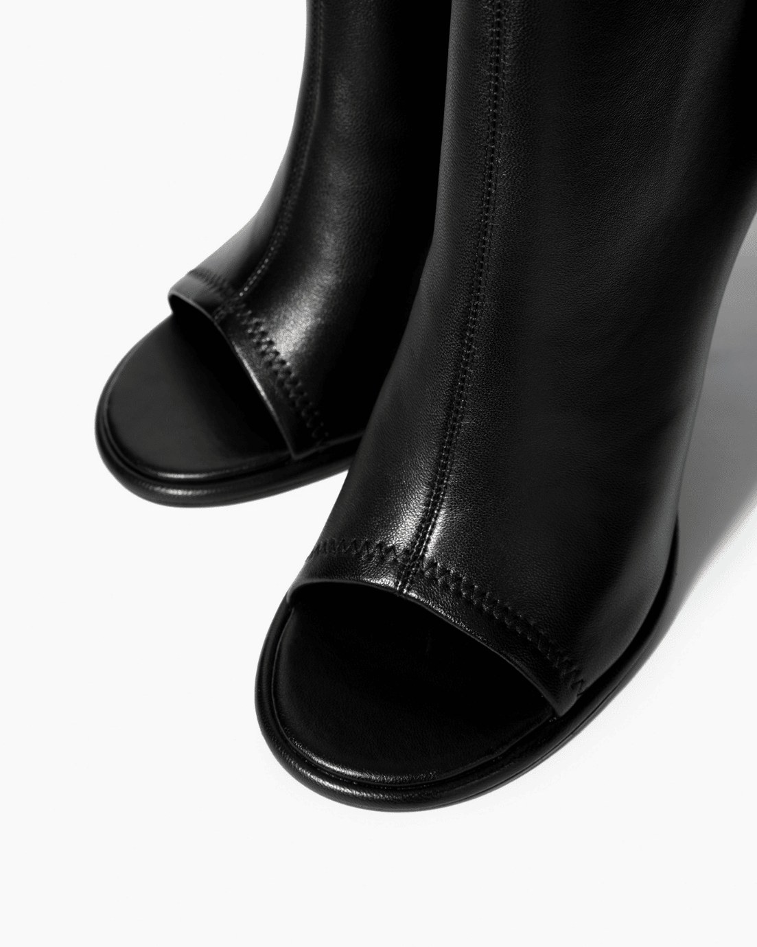 Black leather ankle boots with open toe and tonal stitching