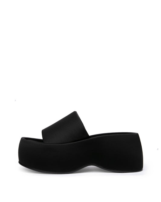 Black structured textile platform slide with a wide single band, side profile