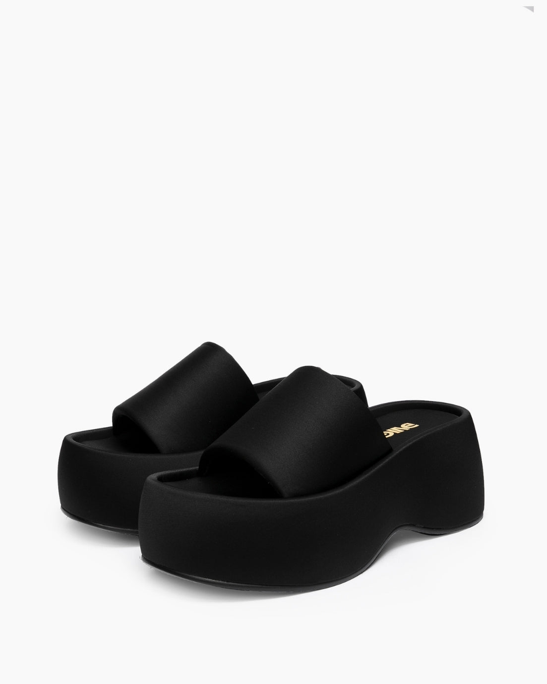 Pair of black platform slides with wide matte textile bands, three-quarter view