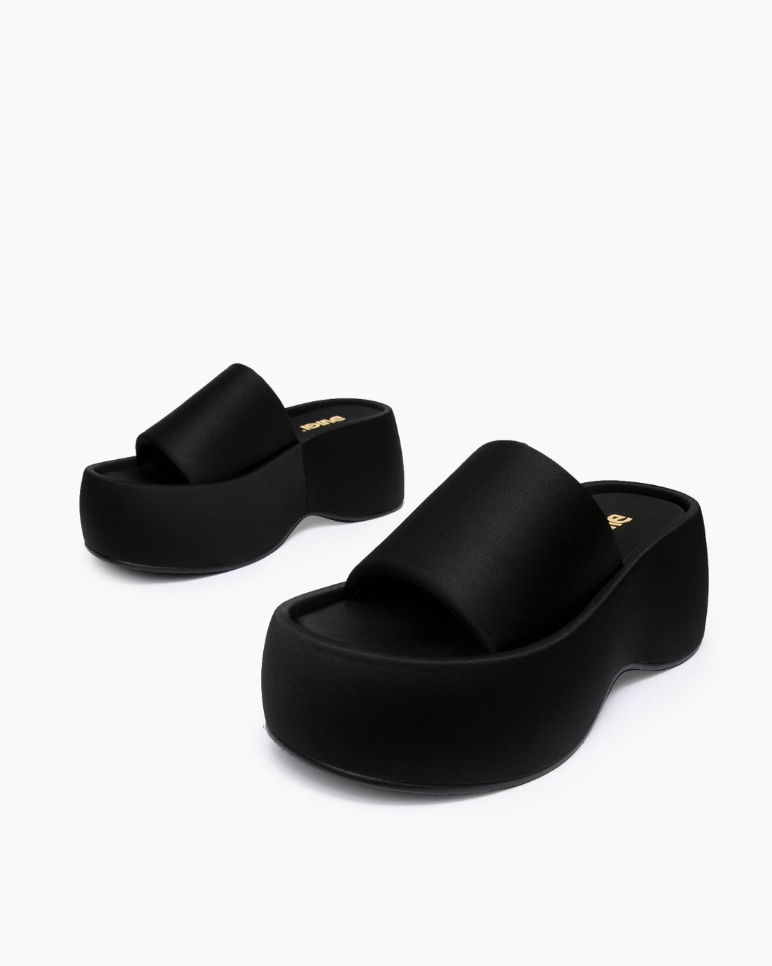 Black textile platform slides arranged at different angles on a white background
