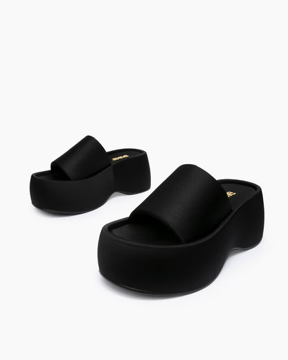 Black textile platform slides arranged at different angles on a white background