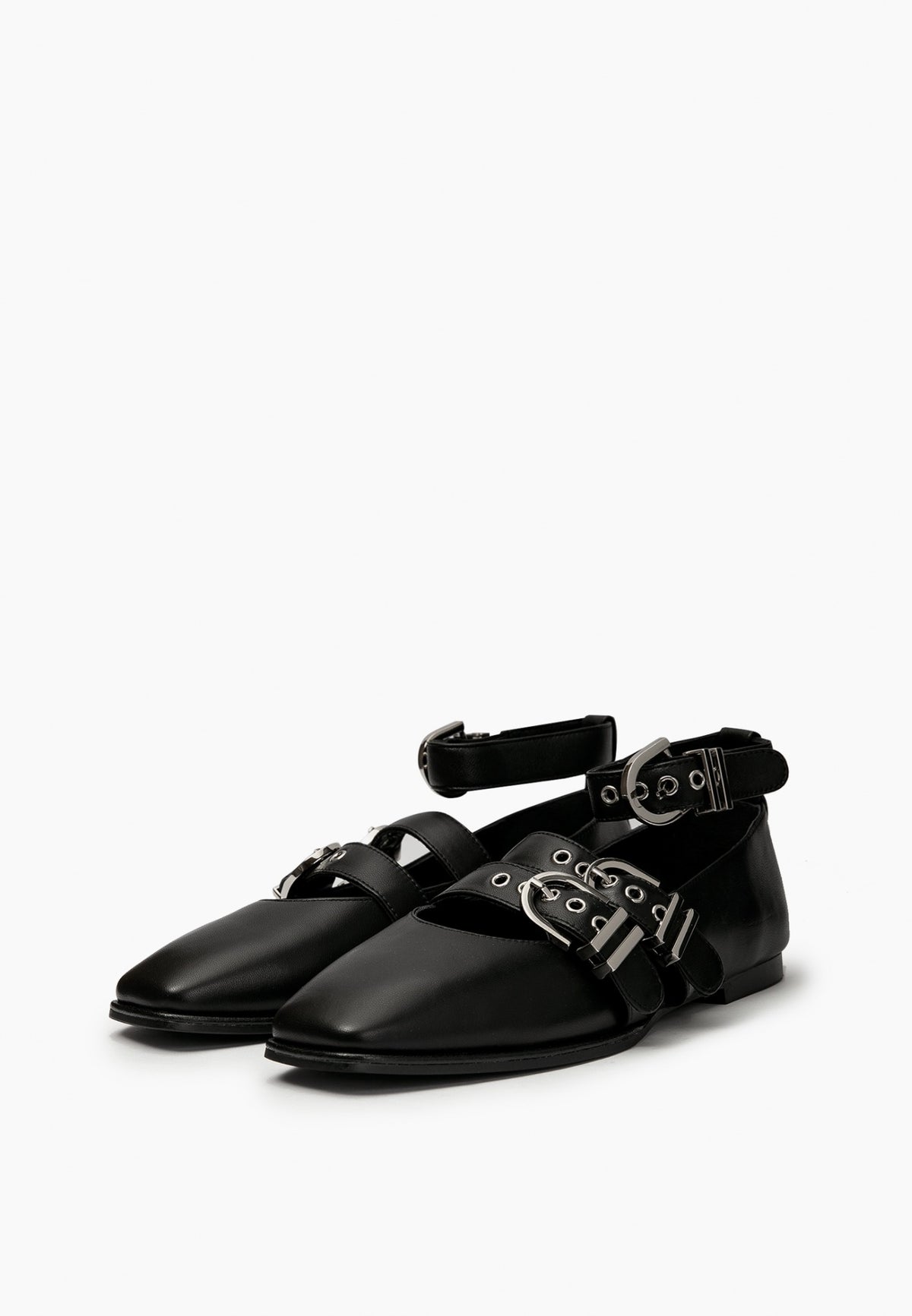 Pair of black leather ballet flats with square toes and silver-tone buckle straps