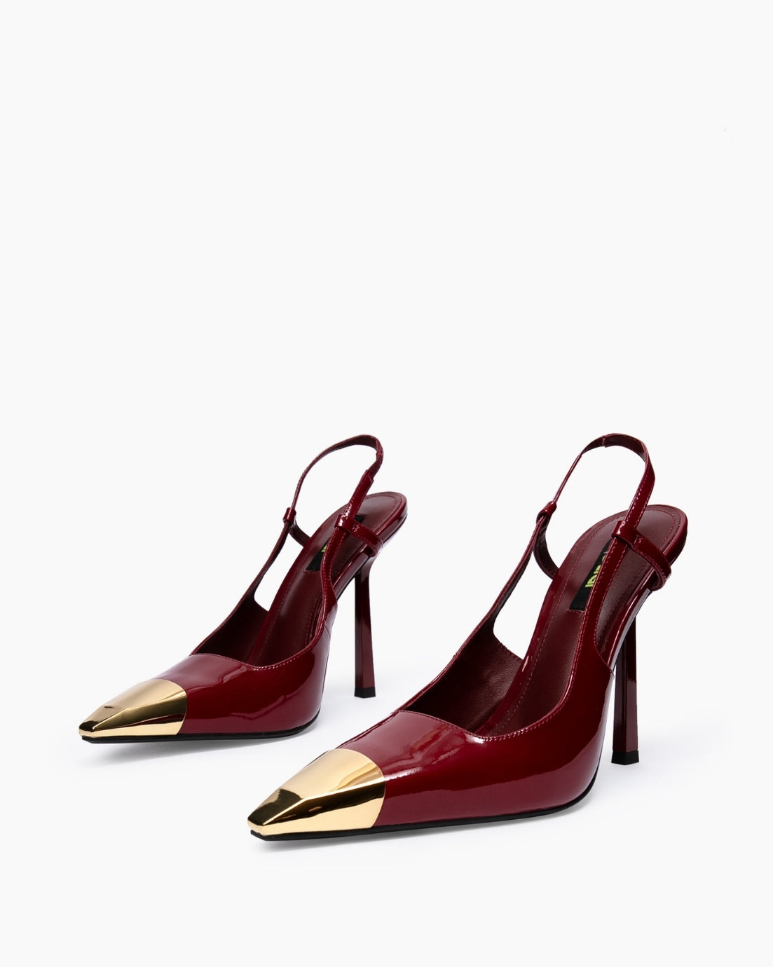 Pair of burgundy patent slingback heels with polished gold-tone pointed toe caps
