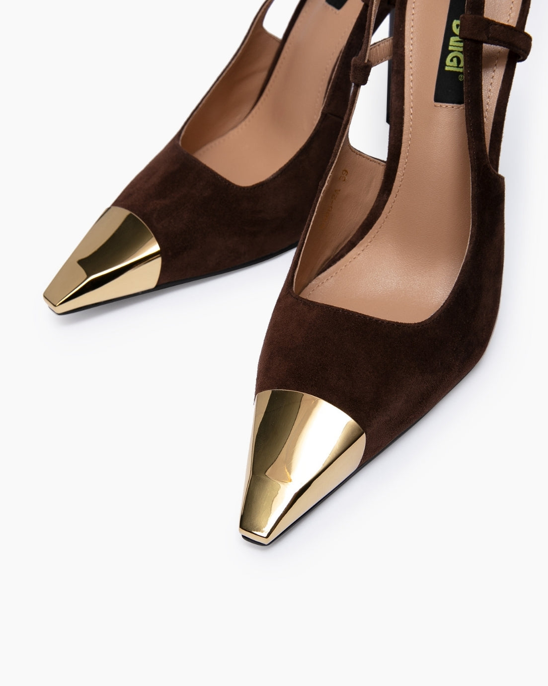 Close-up of velvety brown suede and sculpted gold pointed toe caps