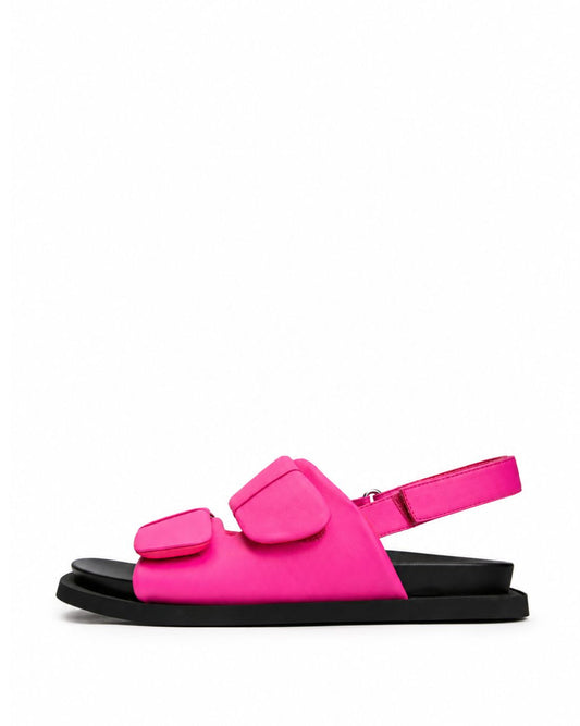 Hot pink soft leather double-strap sandals with adjustable padded straps, side view