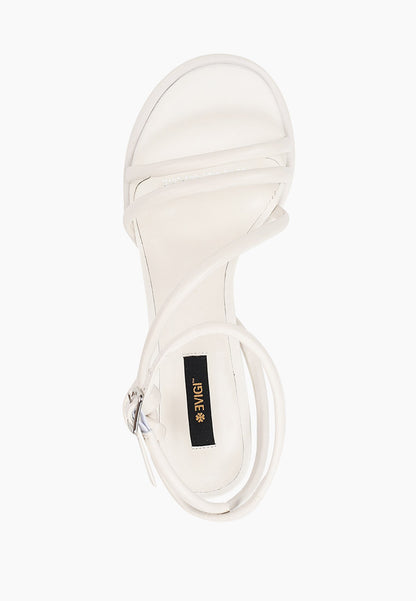 Top view of ivory leather heels with tubular straps and silver buckle
