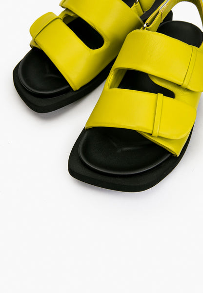 Close-up of lime green padded leather straps and black cushioned footbed