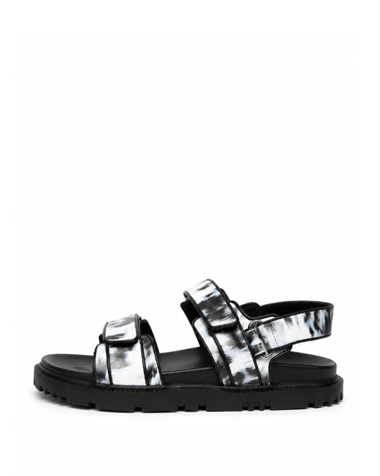 Black and white printed leather sandals with adjustable straps and lug sole, side profile