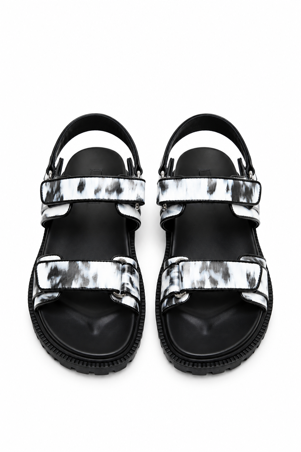 Top view of monochrome printed leather sandals showing three adjustable strap zones