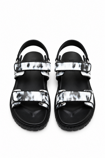Top view of monochrome printed leather sandals showing three adjustable strap zones