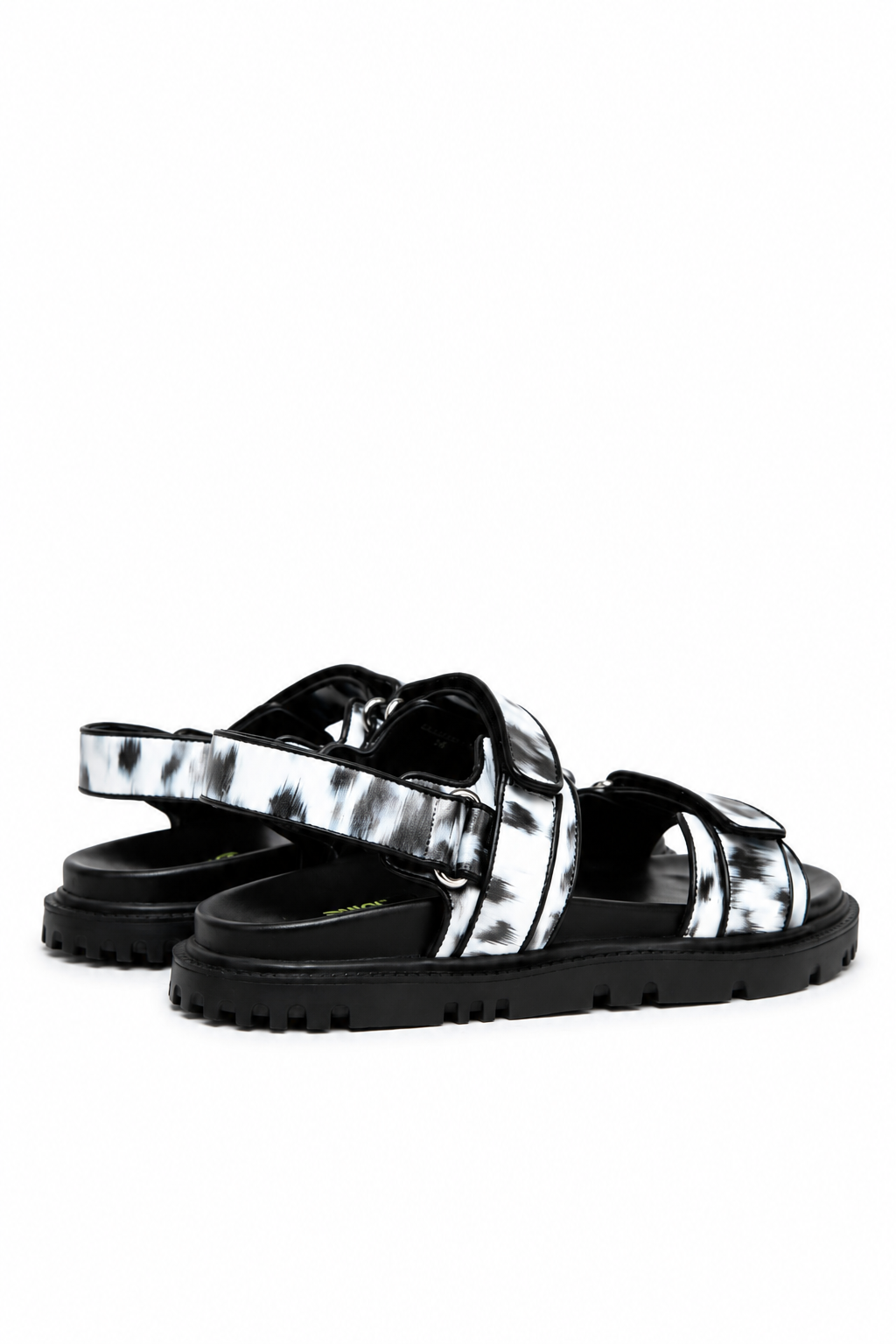 Rear side view of printed leather sandals with ankle strap and black treaded sole