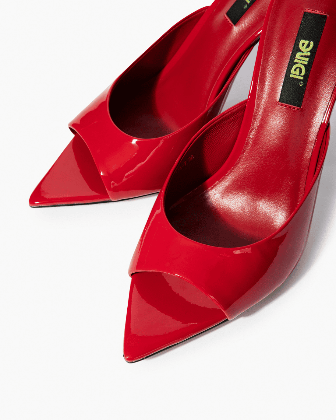 Red patent leather mules with open toe and pointed footbed detail