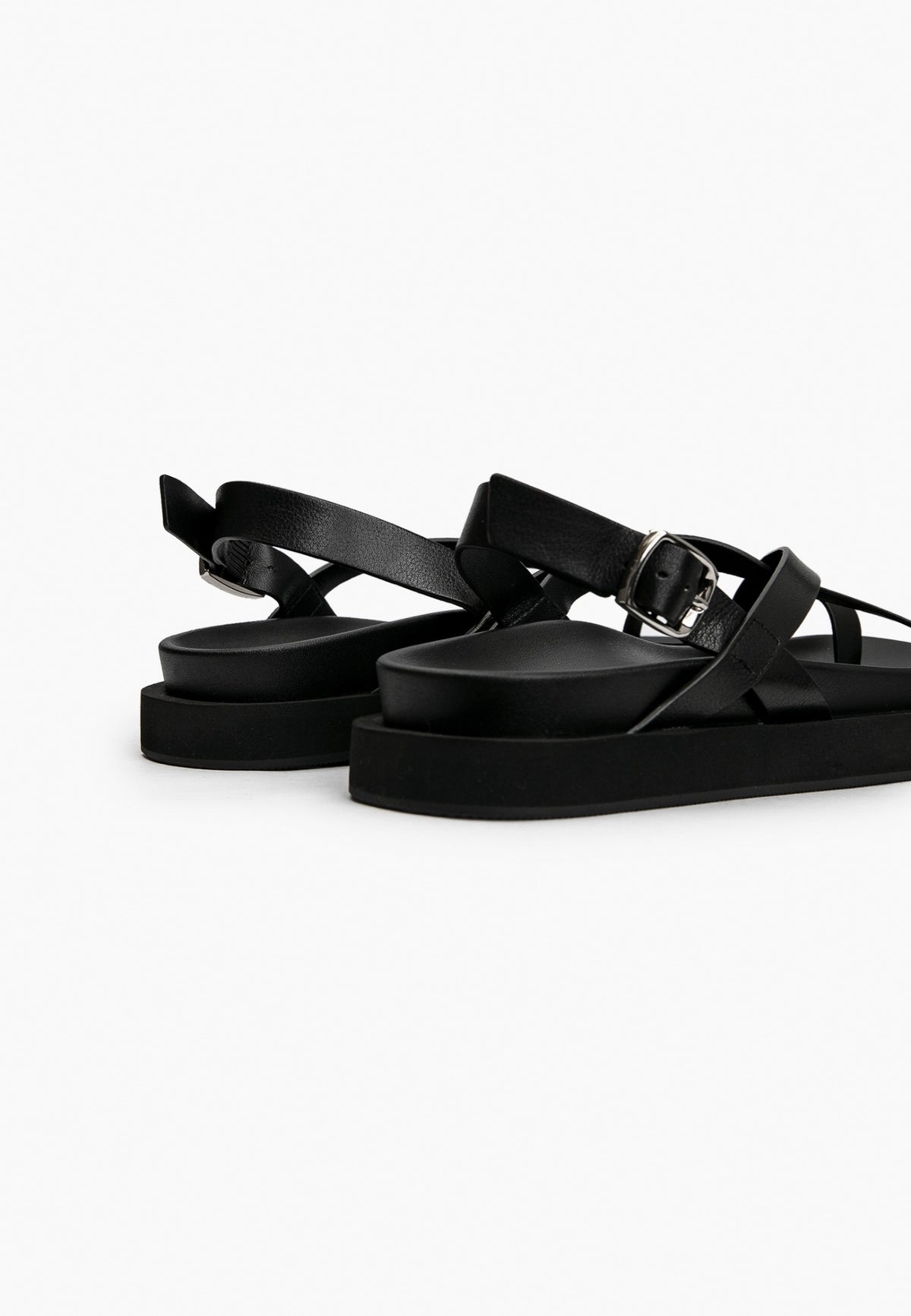 Rear detail of black leather sandal with adjustable silver-tone buckle