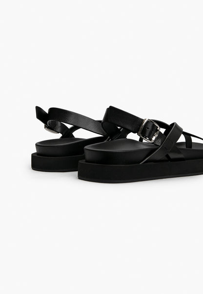 Rear detail of black leather sandal with adjustable silver-tone buckle
