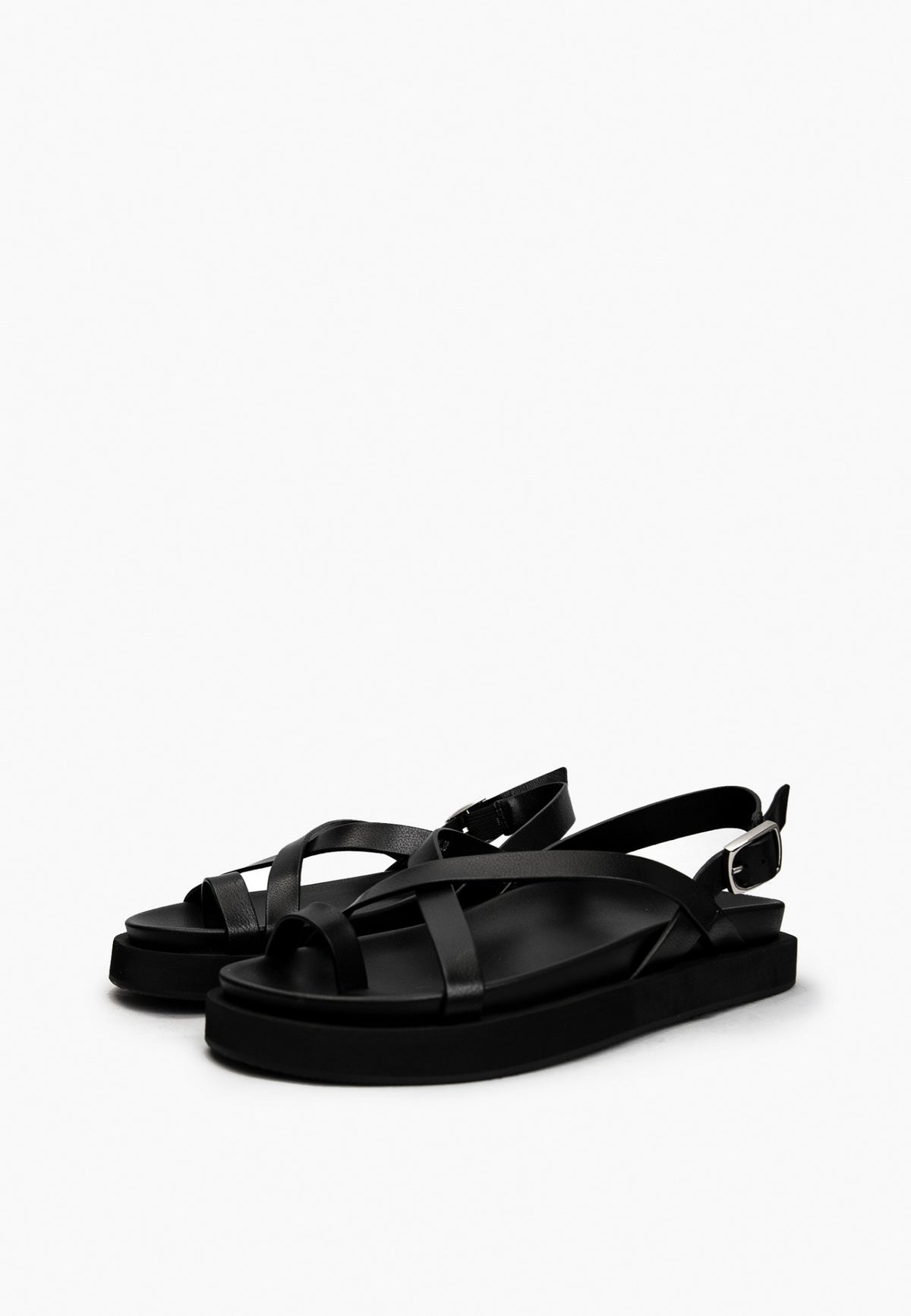 Pair of black leather toe-loop sandals with slim crossover straps