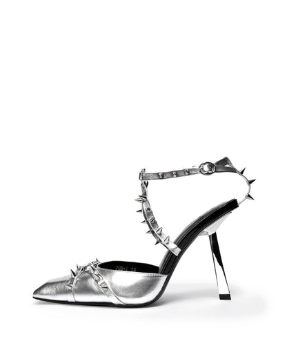 Silver metallic leather heel with spiked ankle straps and an angular heel, side profile