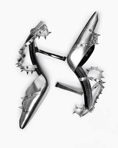 Overhead arrangement of silver leather shoes with contrasting black leather insoles