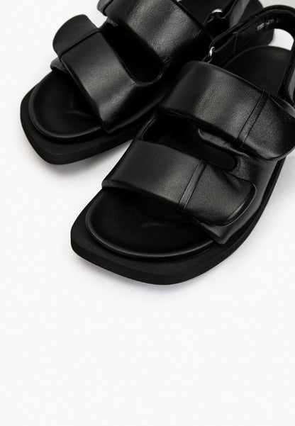 Close-up of soft black leather padded straps and cushioned footbed